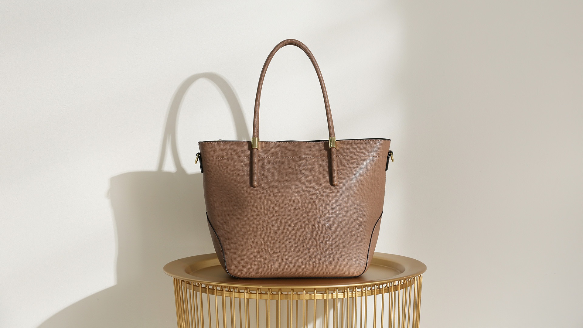 A leather bag in beige from a luxury bag brand in Singapore