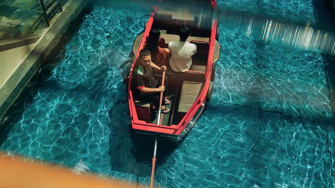 Family of three taking a Sampan ride as a Mother's Day activity in Singapore